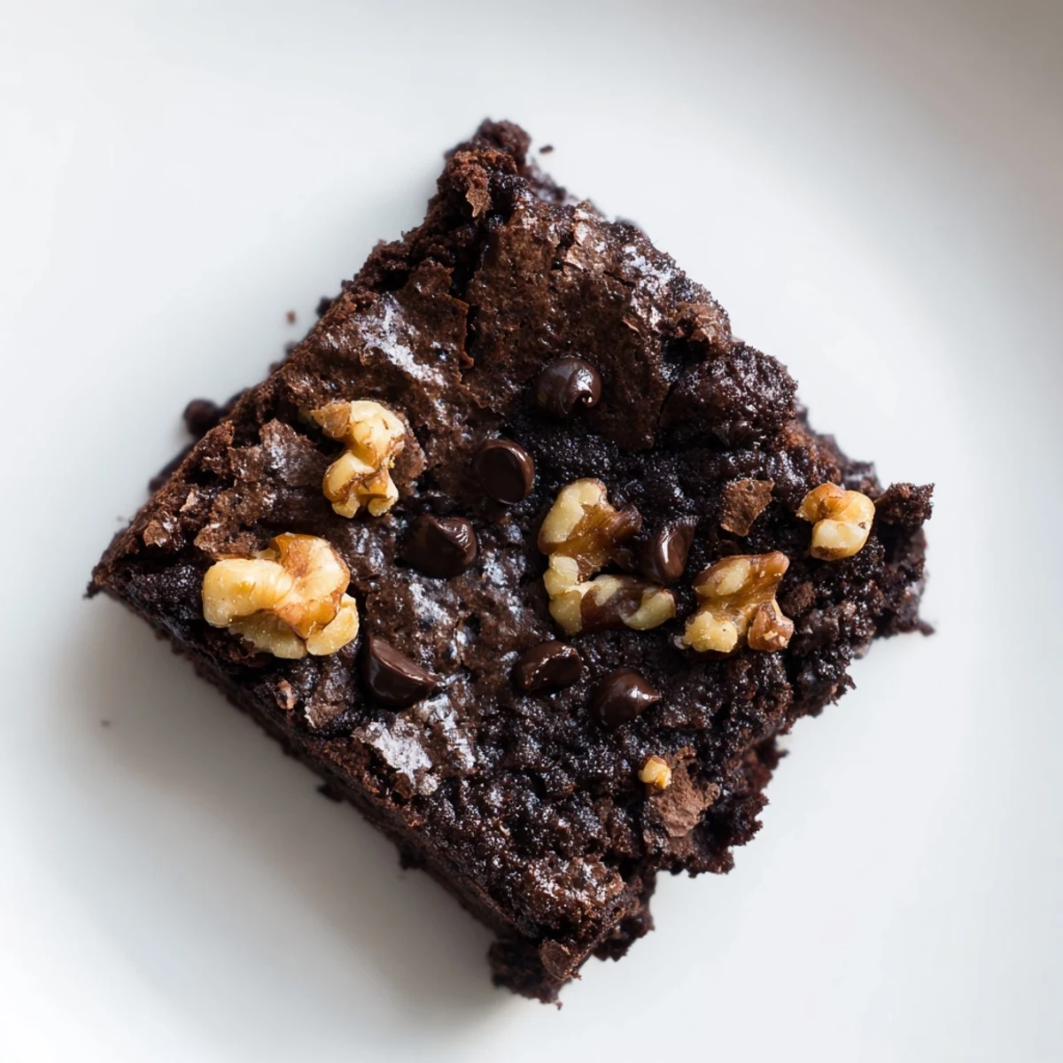 Freshly baked gluten-free almond flour brownies, a close-up showing their moist texture and dark chocolate color.