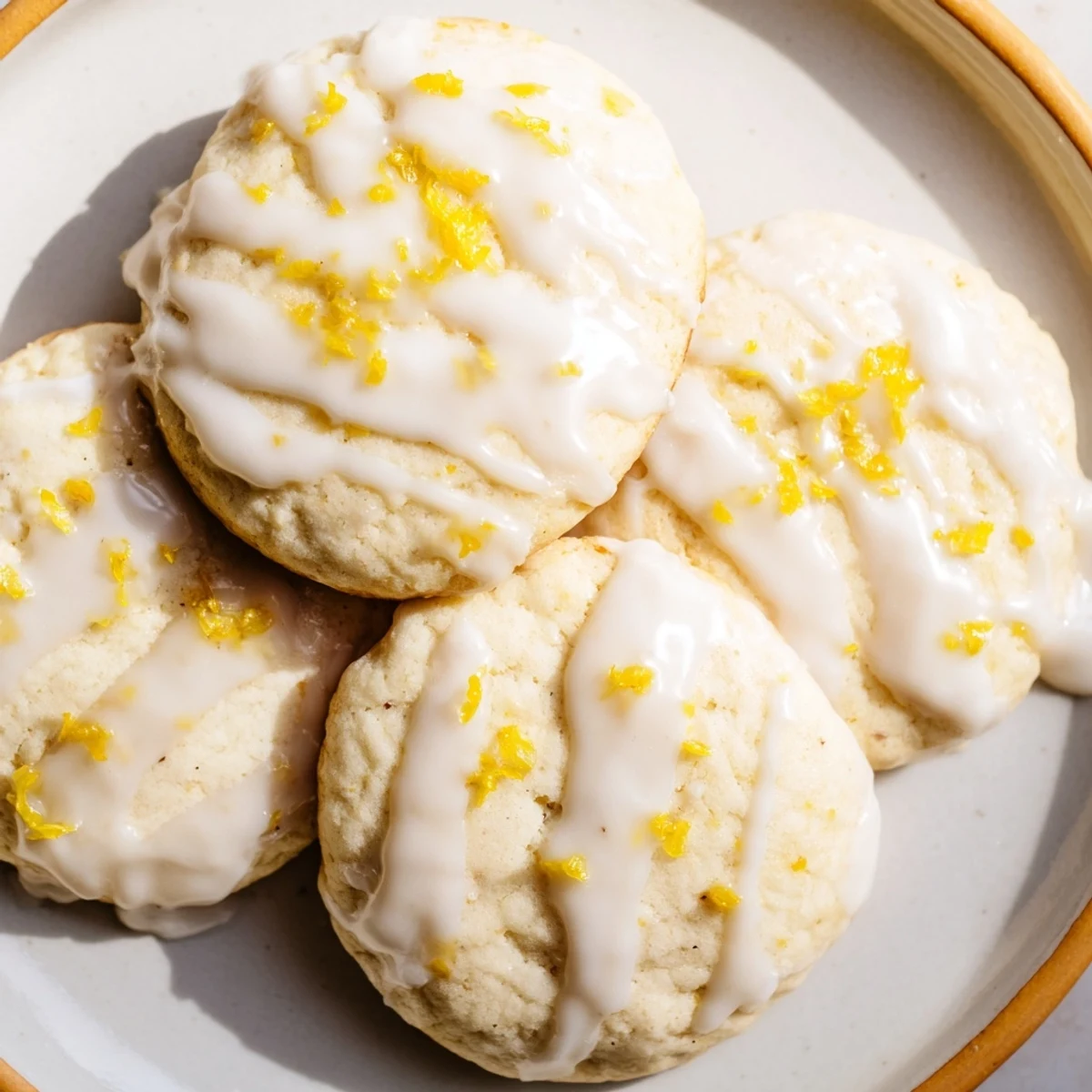 Freshly baked Lemon Ricotta Cookies with sweet lemon glaze, drizzled and arranged on a wire cooling rack.
