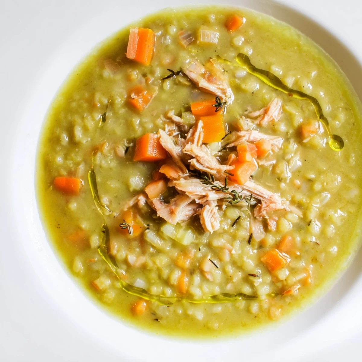 Hearty Green Split Pea Soup with Smoked Turkey served steaming hot in a rustic bowl, garnished with fresh parsley.