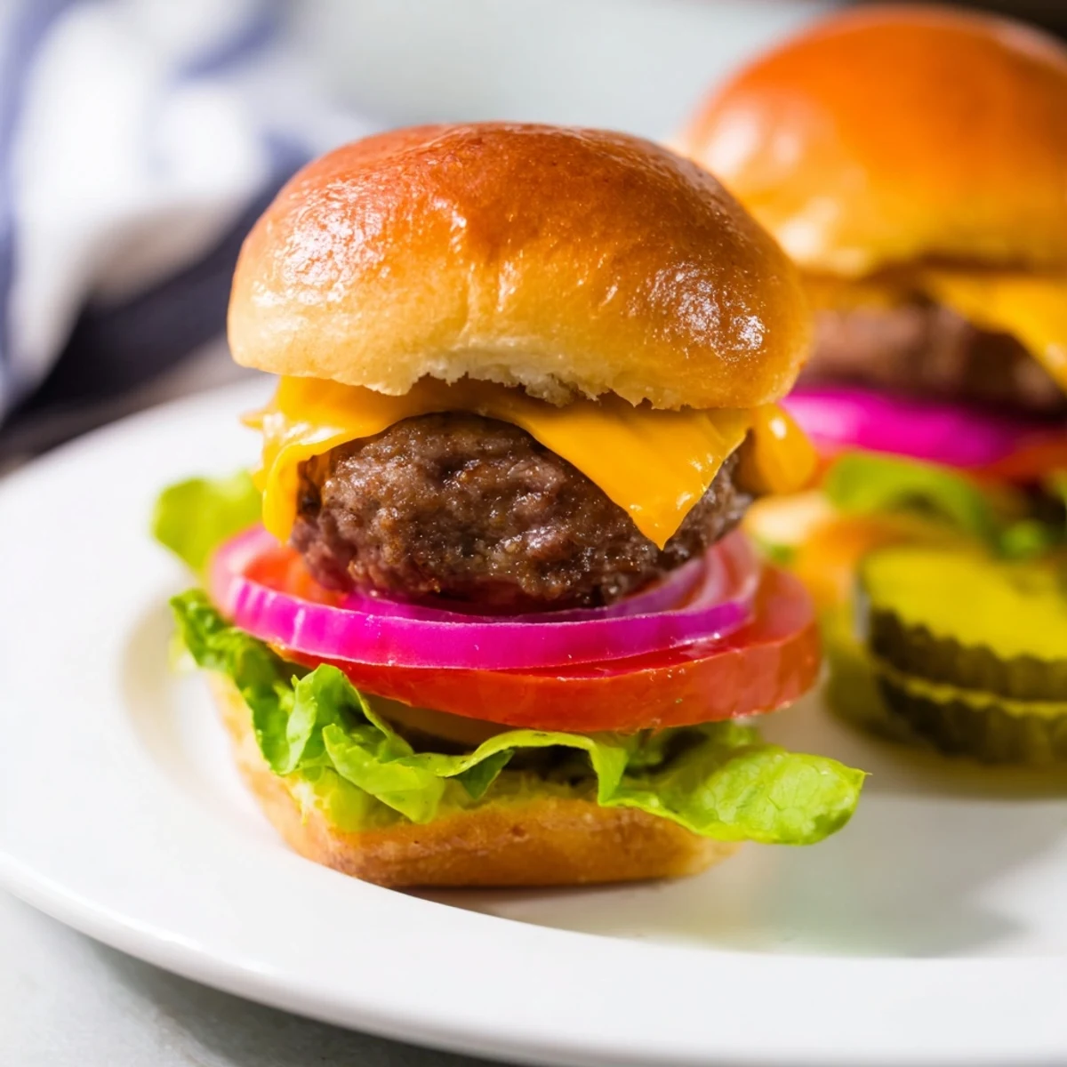 Stack of golden Beef Sliders with Cheddar Cheese, paired with ketchup and mustard for a family-friendly meal.