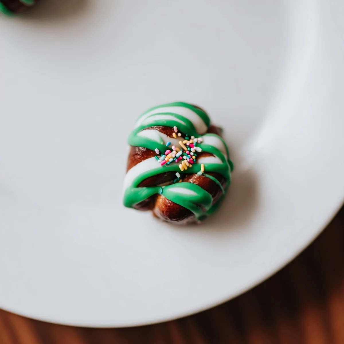 These pretzel treats feature a festive green chocolate drizzle on salty mini twists, perfect for holiday parties and snacking.