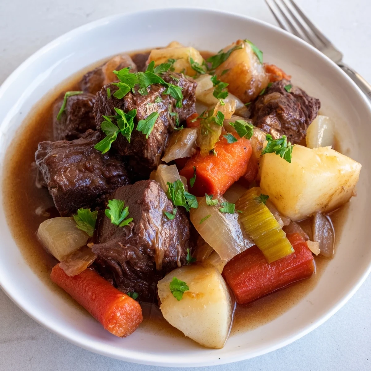 Hearty Beef Stew with Root Vegetables served steaming in a rustic bowl, perfect for a cozy family dinner.  