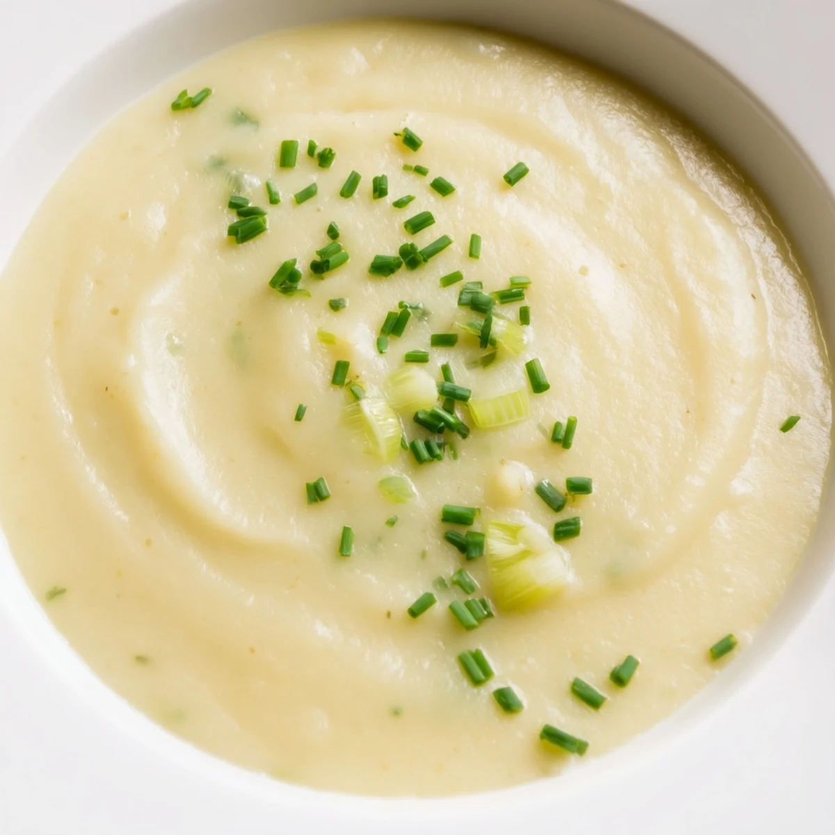 Velvety Creamy Potato and Leek Soup served alongside crusty artisan bread for dipping.