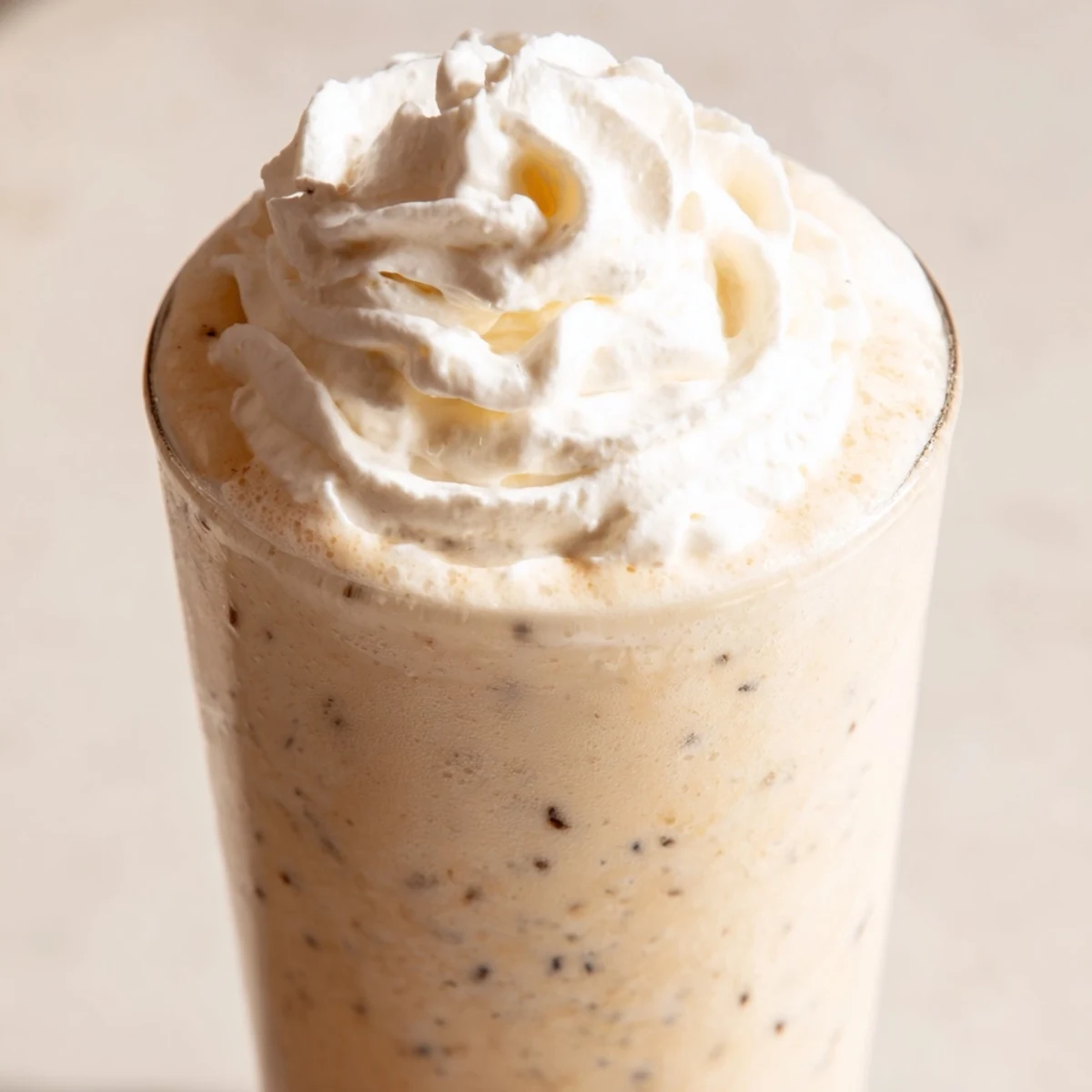 Close-up of a Starbucks Vanilla Bean Frappuccino with fluffy whipped cream, perfect for a sweet afternoon treat.