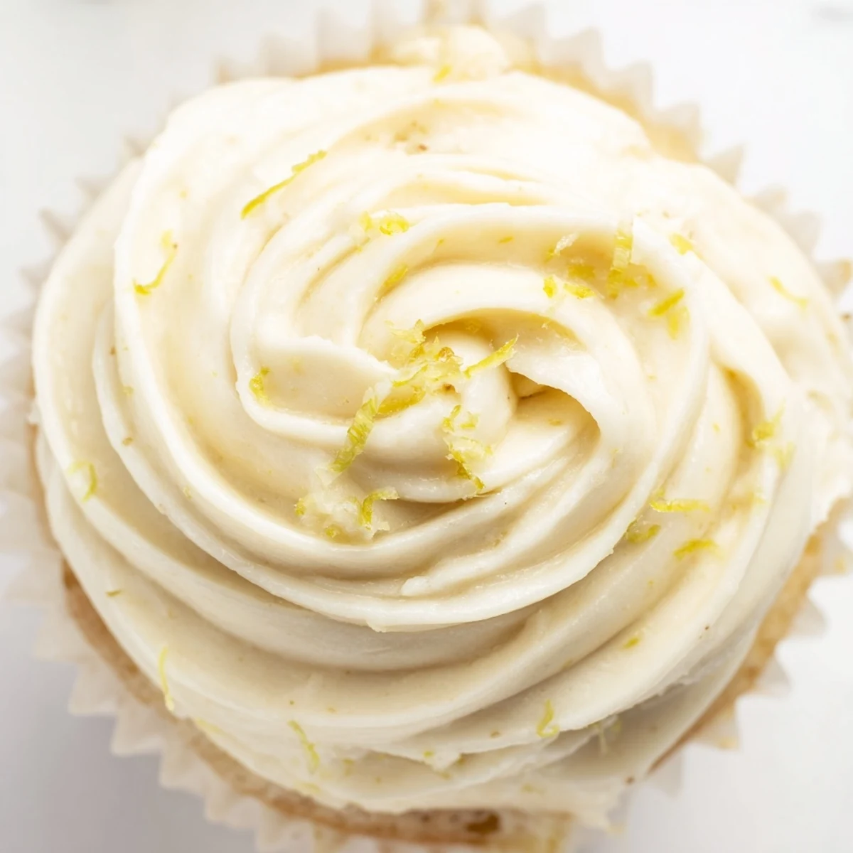 Tender vanilla cupcakes brushed with sweet elderflower syrup, topped with creamy elderflower buttercream and a lemon zest garnish for spring.