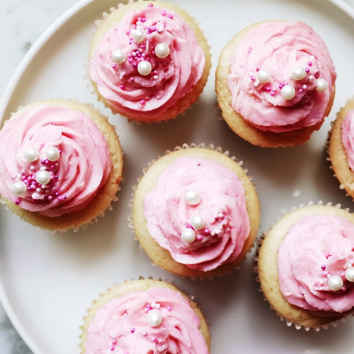 Moist vanilla Girl Baby Shower Cupcakes piped with fluffy pink buttercream and baby-themed toppers for a sweet celebration.