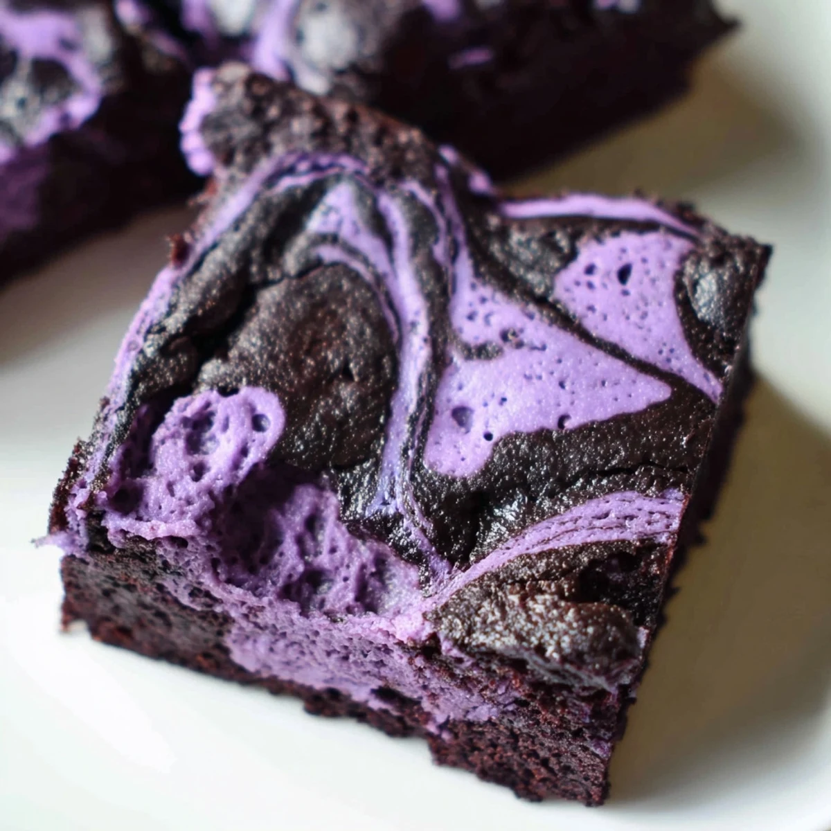 Vibrant purple Filipino ube brownies featuring a marbled chocolate and purple yam dessert