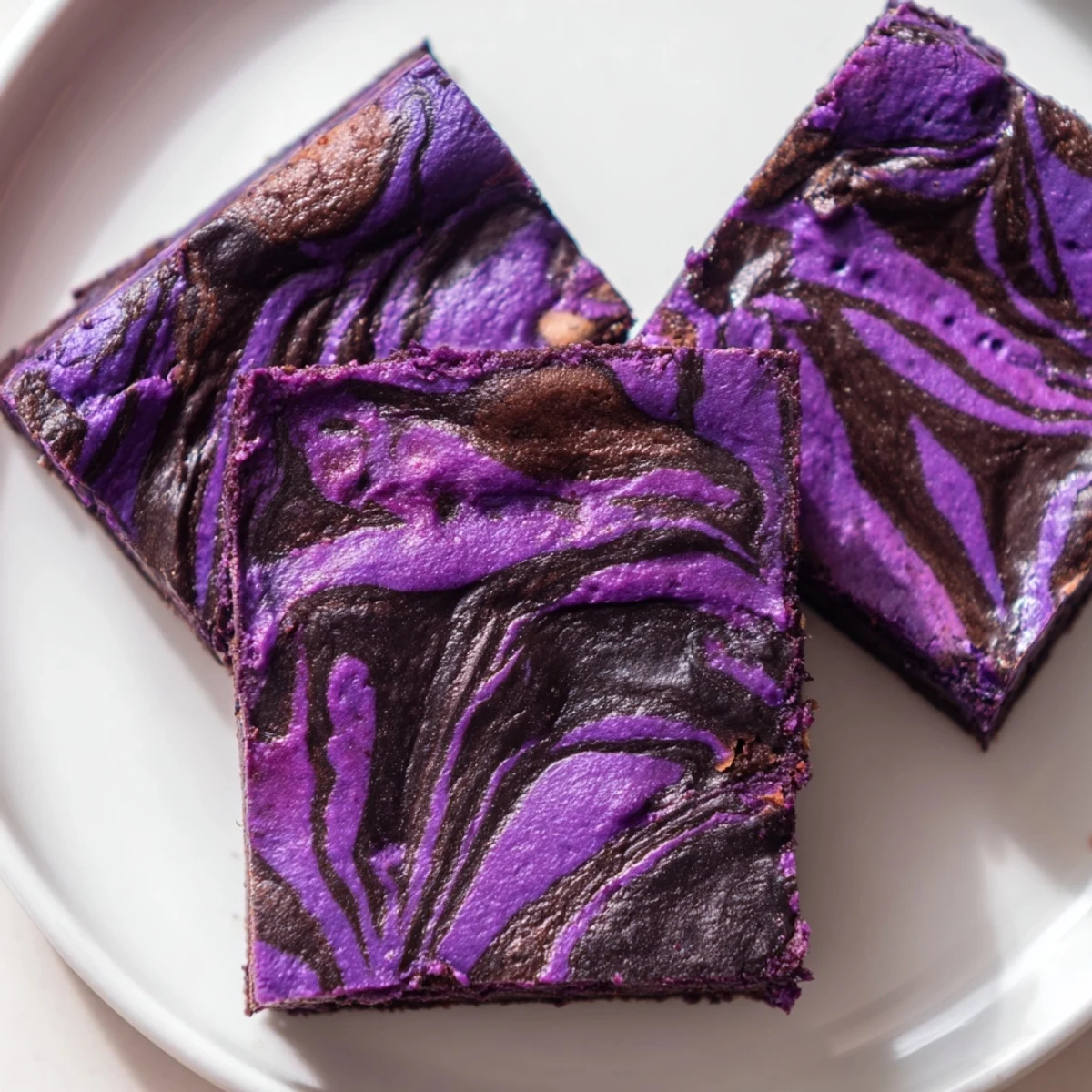 Homemade ube brownies cut into squares showing the moist purple crumb texture
