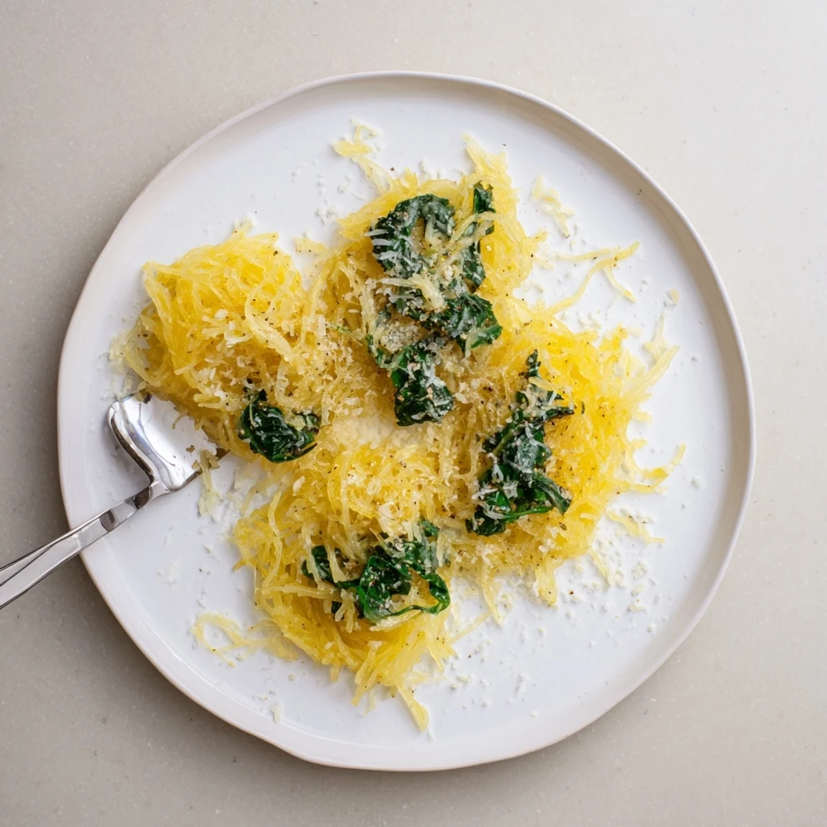 Baked spaghetti squash strands tossed with garlic Boursin cheese and fresh baby spinach leaves