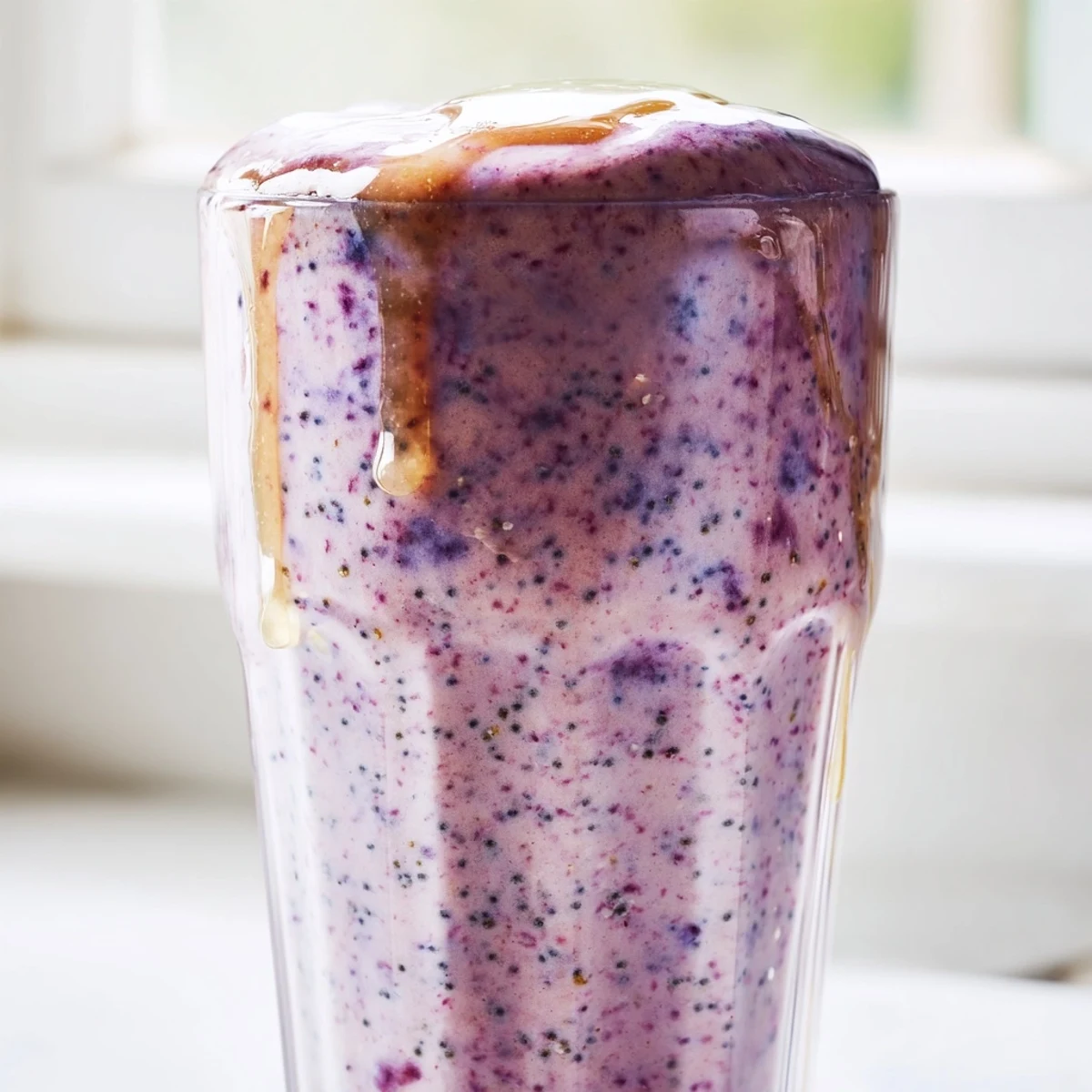 Protein-packed Greek yogurt breakfast smoothie poured into tall glass with strawberry garnish