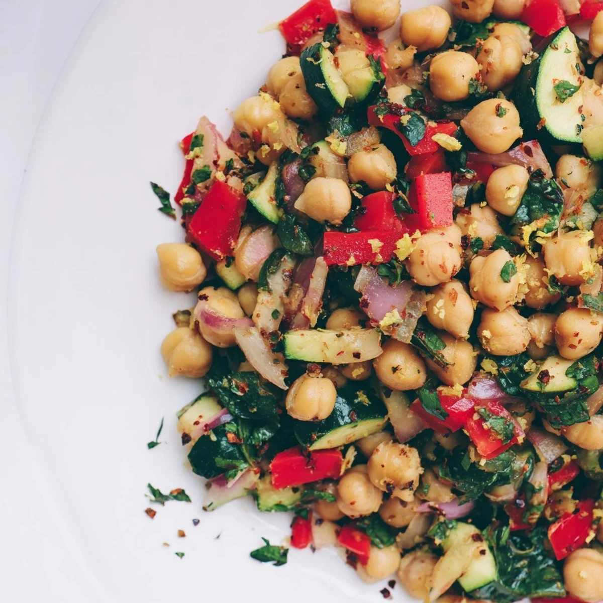 Mediterranean-style chickpea lemon skillet featuring tender vegetables in a zesty sauce