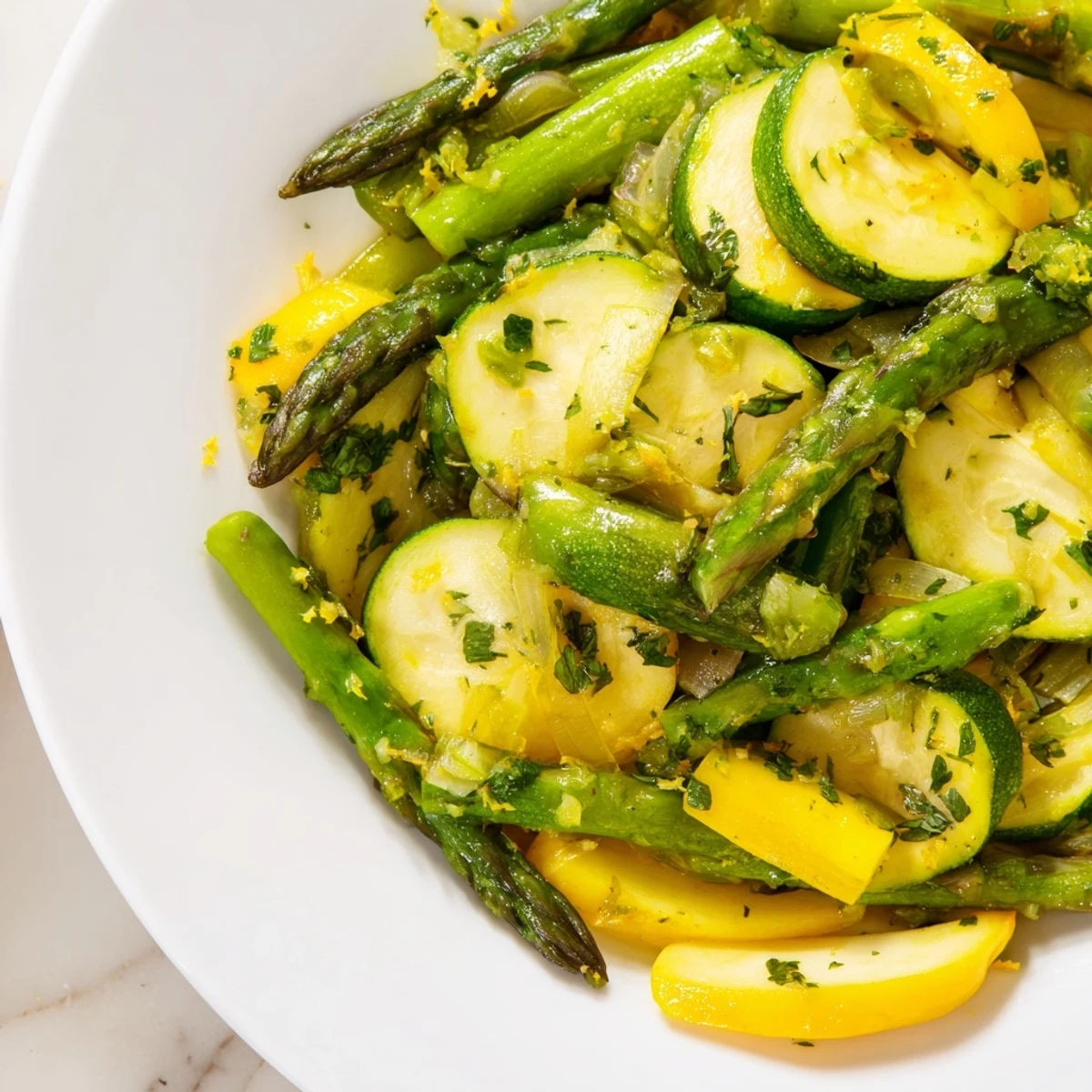 Vibrant sautéed asparagus with zucchini and yellow squash featuring tender crisp vegetables and fresh herbs