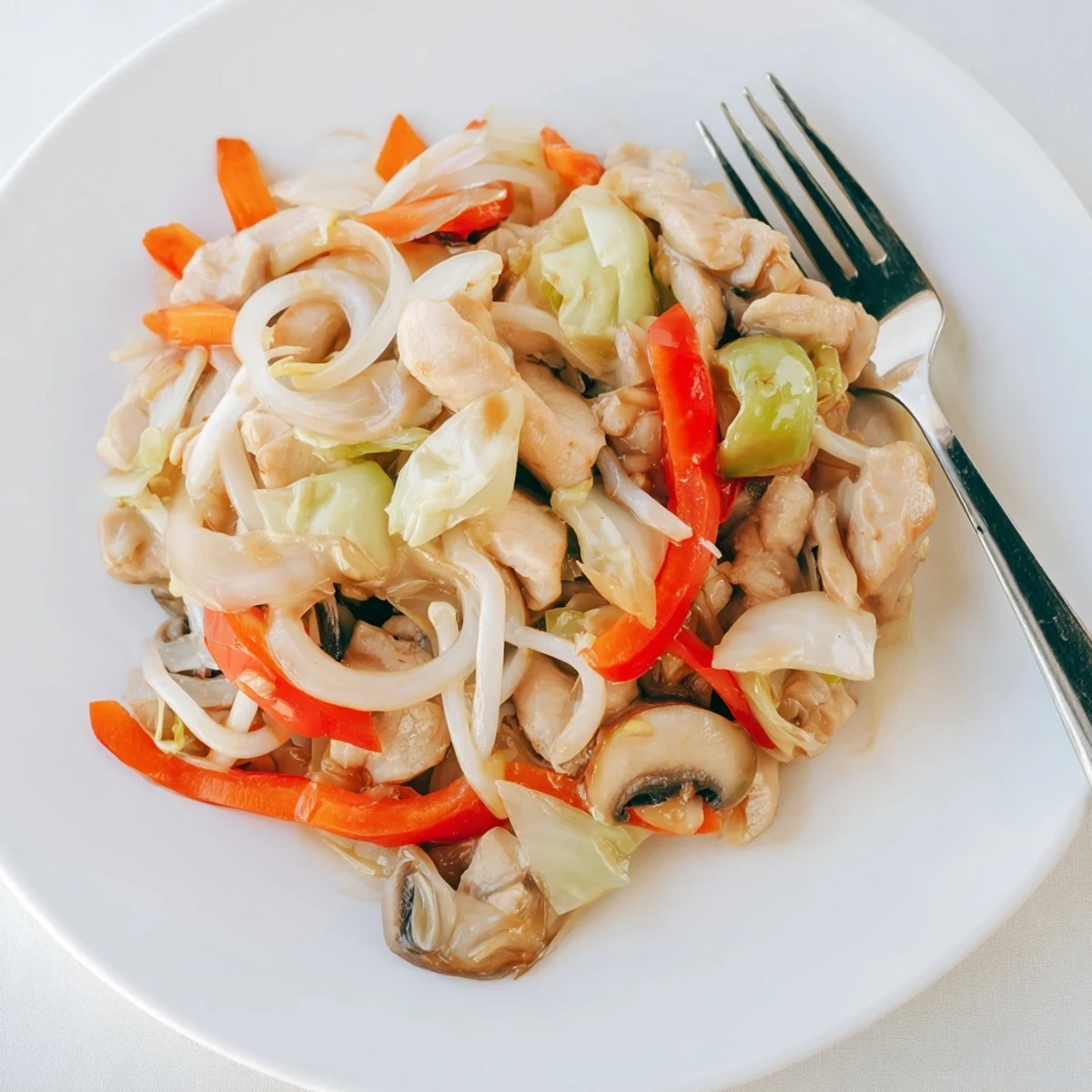 Golden Chop Suey stir-fry with tender chicken, crisp colorful vegetables, and glossy savory sauce served over steaming white rice