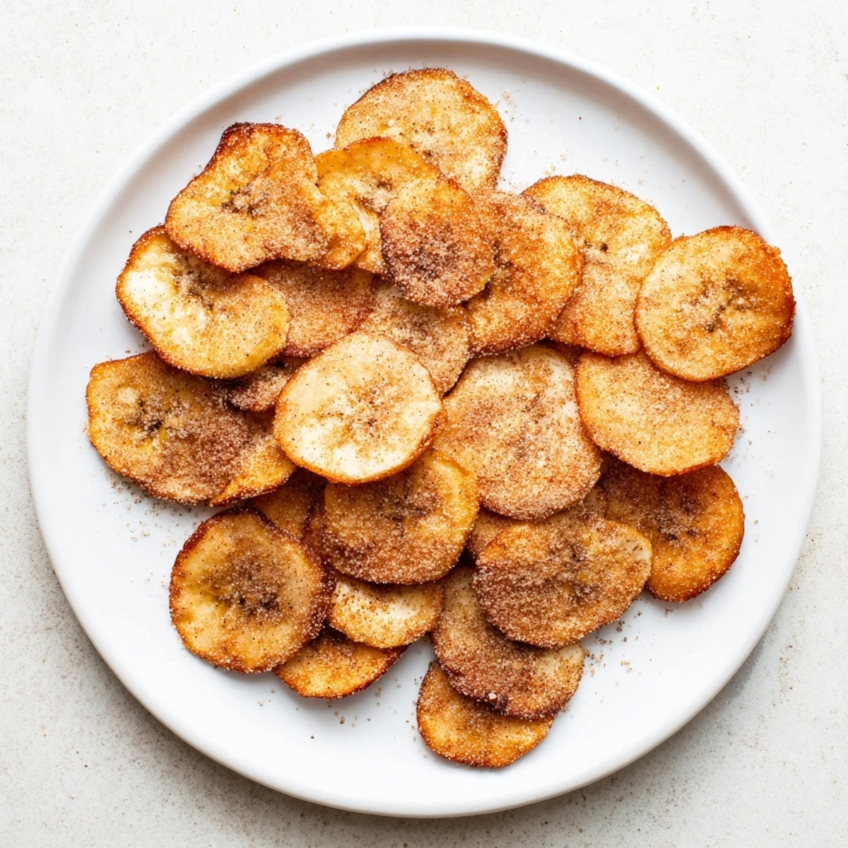 Crispy banana chips coated in sweet cinnamon sugar made in the air fryer basket