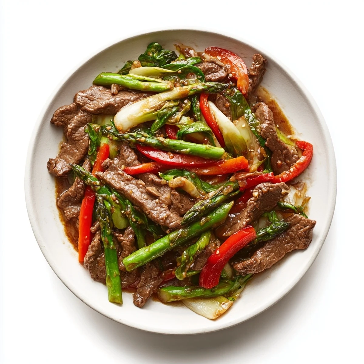 Homemade soy beef bok choy and asparagus stir fry with vibrant greens and savory glazed beef slices
