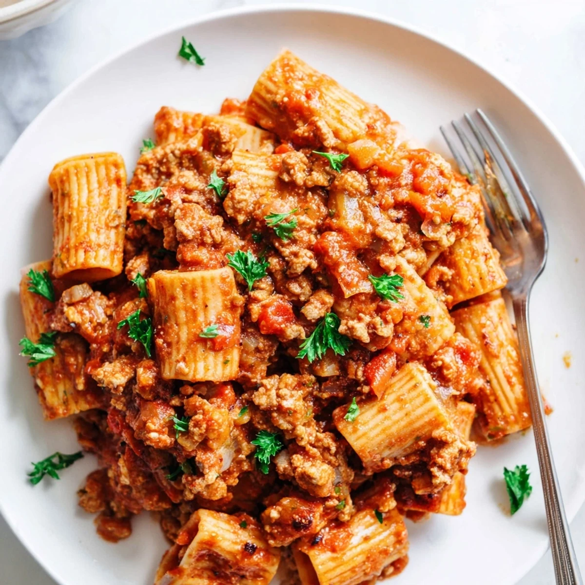 Rich ground Turkey Bolognese simmered with tomatoes, vegetables, and aromatic herbs over spaghetti noodles