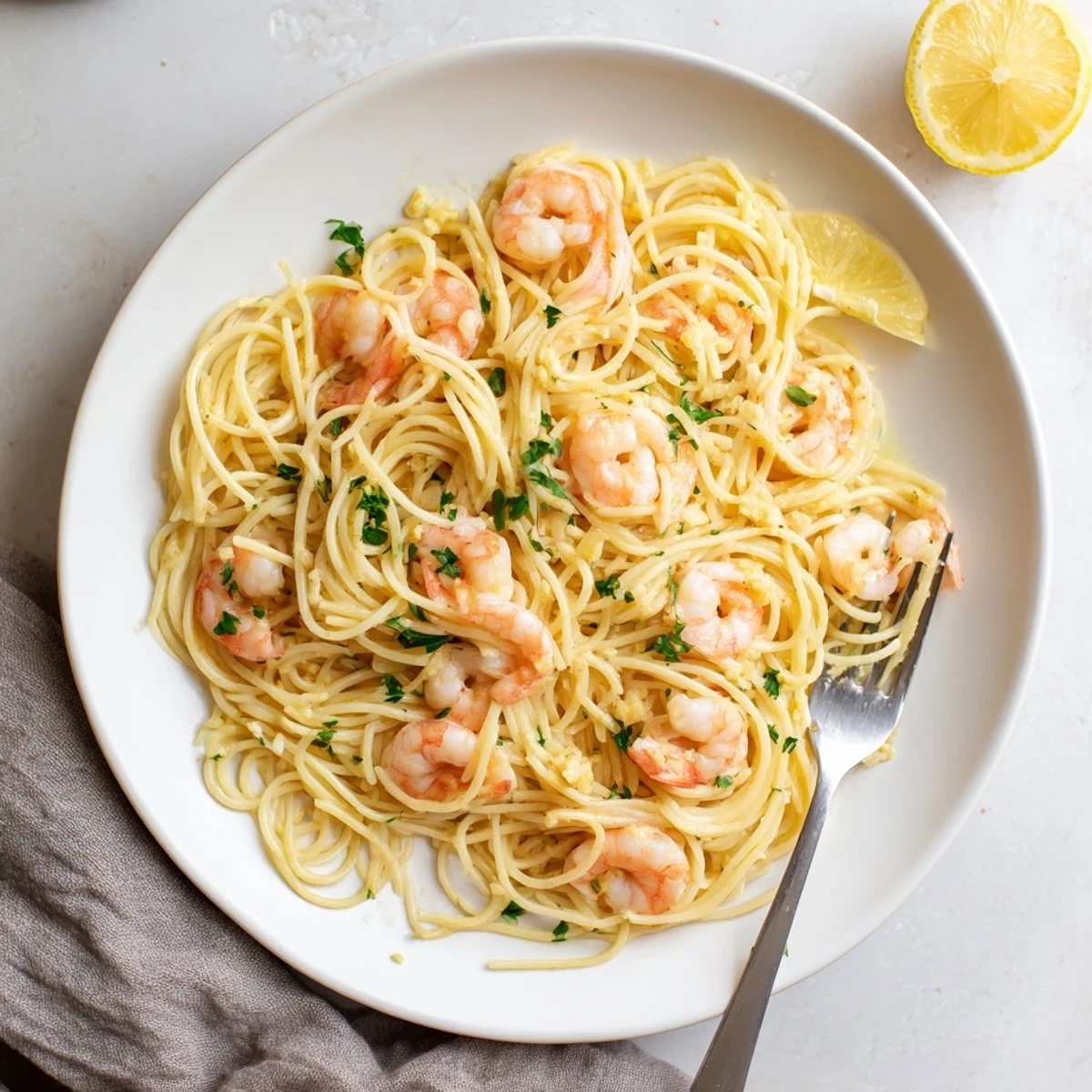 Creamy garlic shrimp scampi pasta tangled with spaghetti in a white wine glaze