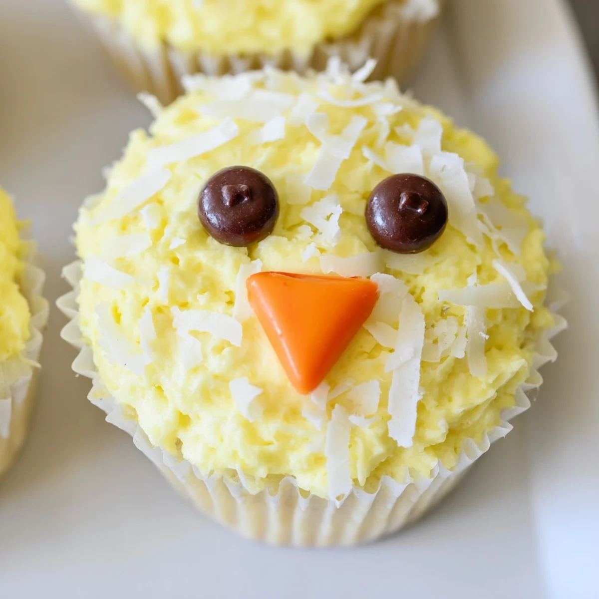 Cute Easter Chick Cupcakes topped with swirled buttercream frosting and mini chocolate chip eyes