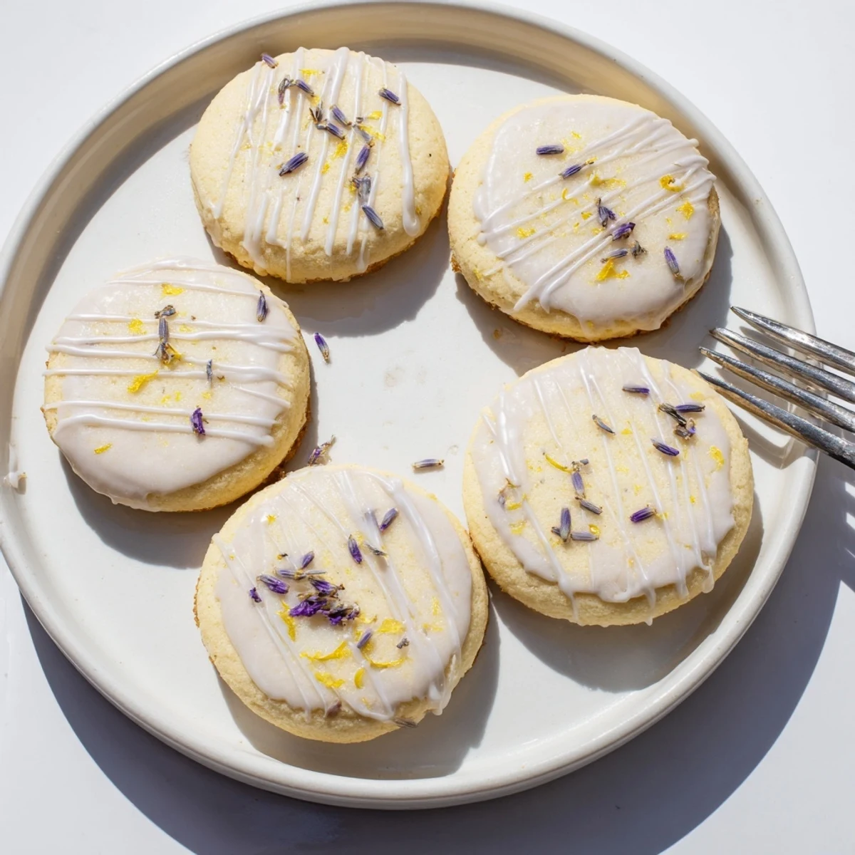 Chewy lemon lavender cookies topped with sweet citrus glaze on a cooling rack