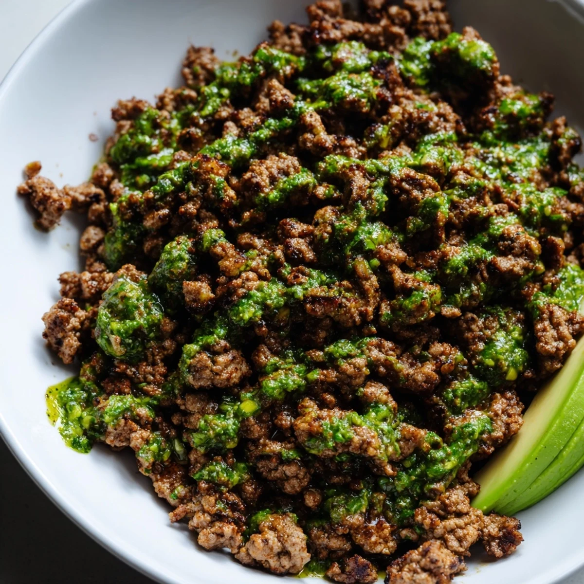 Chimichurri ground beef bowls with seasoned meat, fresh herbs, and crisp vegetables over fluffy white rice