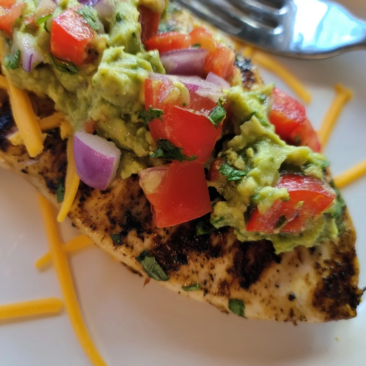Zesty fiesta lime chicken topped with creamy avocado and fresh cilantro