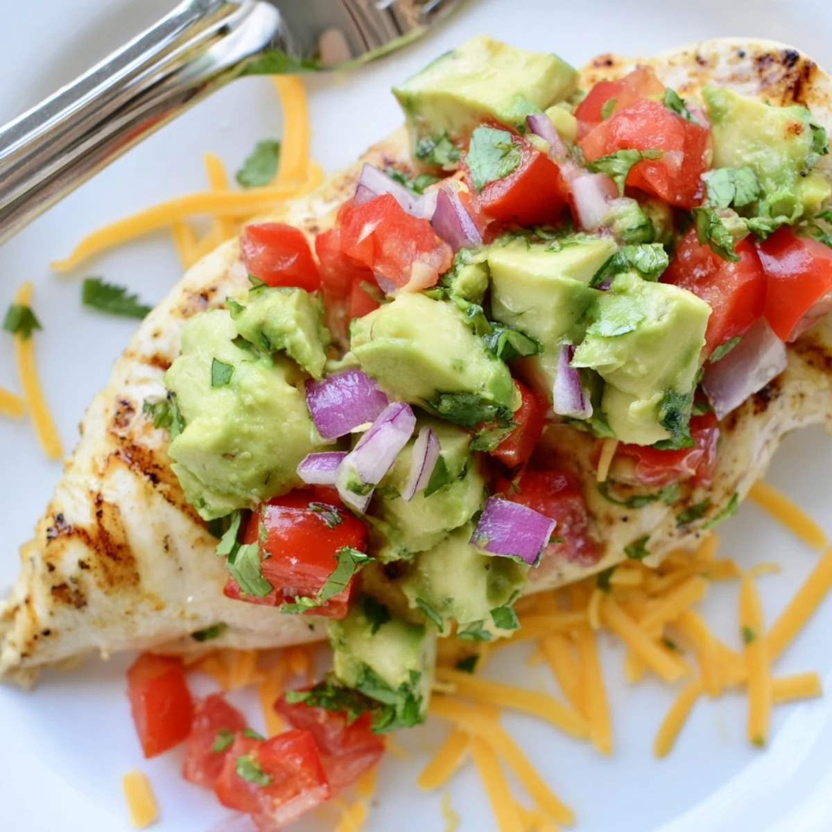 Sizzling skillet fiesta lime chicken with diced avocado and lime wedges