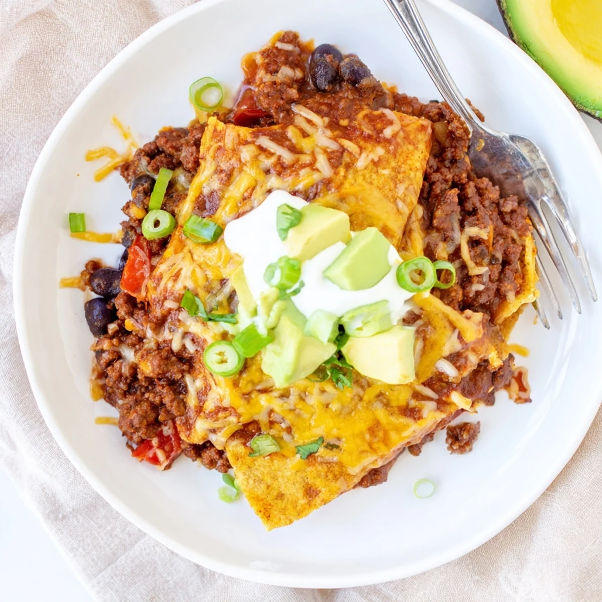 Beef Skillet Enchiladas bubbling in cast-iron skillet with melted cheese, cilantro