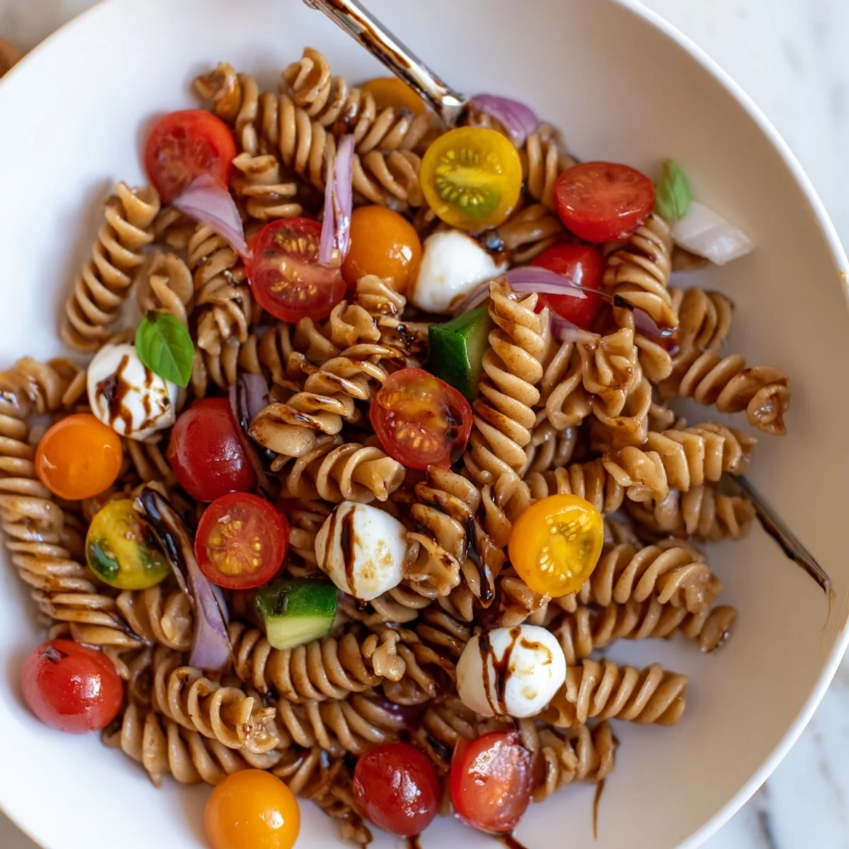 Bright, chilled Colorful Caprese Pasta Salad tossed in zesty balsamic vinaigrette.