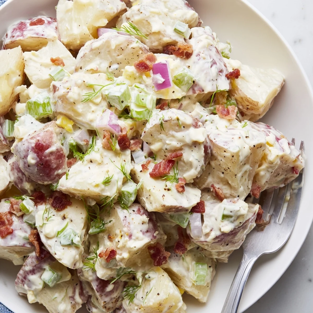 Hearty Steakhouse Potato Salad spooned beside grilled steak, smoky paprika aroma