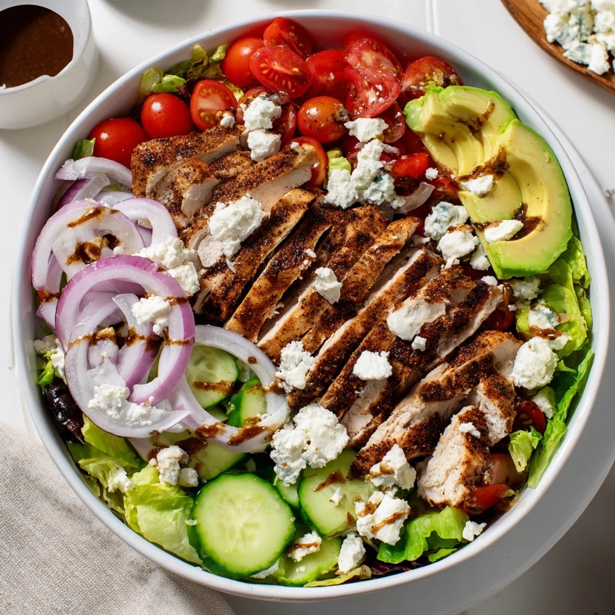 Sliced grilled chicken breast over fresh mixed greens, avocado, cherry tomatoes, and crunchy almonds