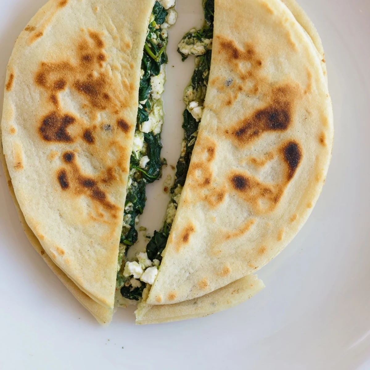 Savory spinach and feta stuffed Turkish Gozleme served hot with melted cheese filling