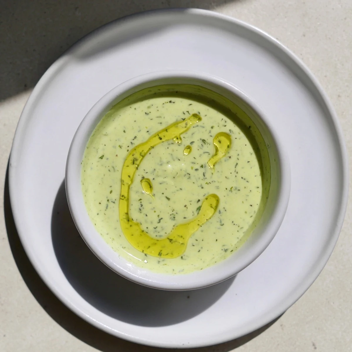Creamy cilantro lime sauce drizzled over grilled chicken tacos with fresh garnish