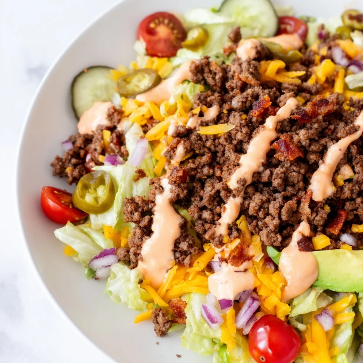 Juicy burger bowls loaded with seasoned beef, crisp lettuce, and melted cheddar cheese